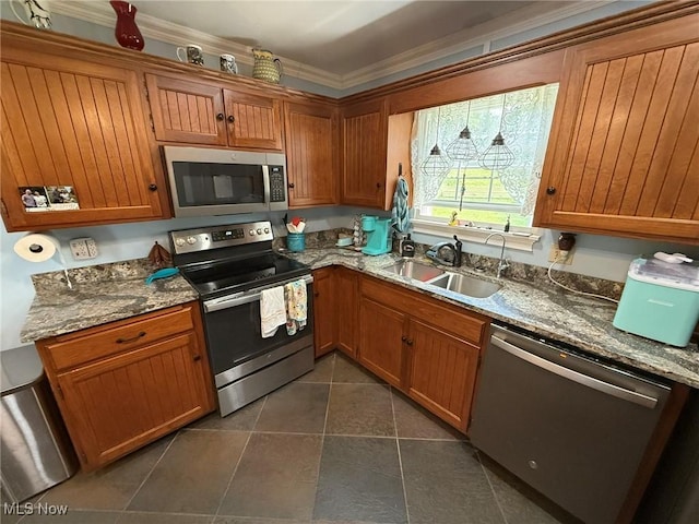 22399 Township Rd Unit 1203, West Lafayette, OH 43845 - kitchen with stainless steel appliances, brown cabinetry, dark tile patterned flooring, stone counters, and ornamental molding