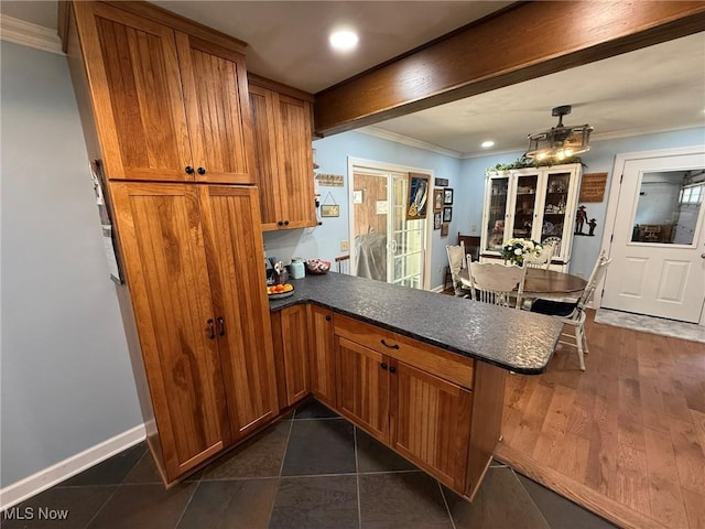 22399 Township Rd Unit 1203, West Lafayette, OH 43845 - kitchen with brown cabinets, a peninsula, dark countertops, ornamental molding, and recessed lighting