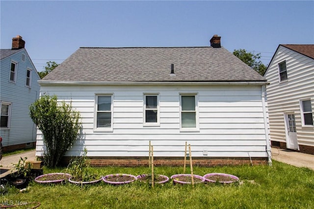 14112 Rockside Rd, Maple Heights, OH 44137 - back of property with a chimney, a shingled roof, and a yard