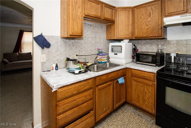 14112 Rockside Rd, Maple Heights, OH 44137 - kitchen featuring black range with electric stovetop, under cabinet range hood, light countertops, and tasteful backsplash
