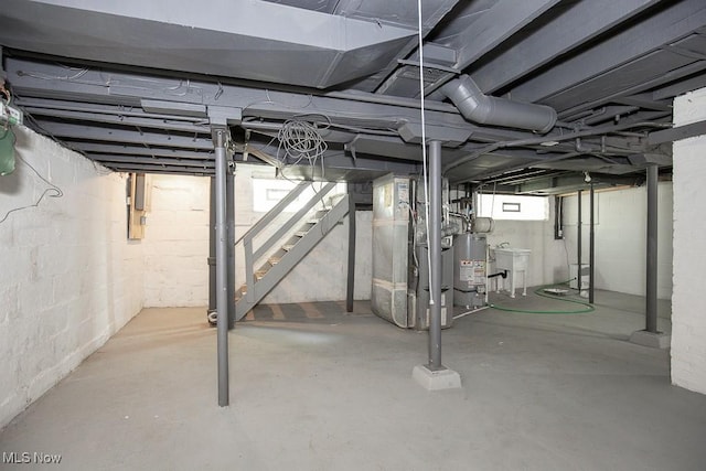 381 Watson St, Akron, OH 44305 - basement with gas water heater, stairway, and heating unit