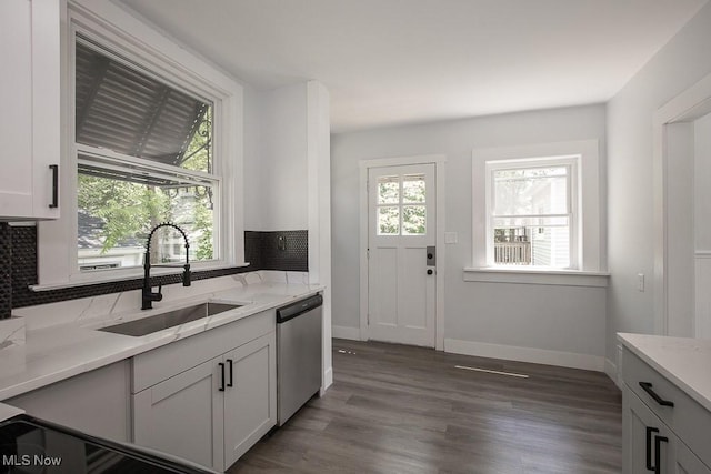 381 Watson St, Akron, OH 44305 - kitchen with stainless steel dishwasher, backsplash, wood finished floors, light stone counters, and white cabinetry