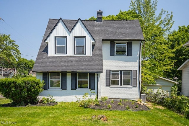 381 Watson St, Akron, OH 44305 - view of front facade with a front yard, board and batten siding, a shingled roof, and brick siding