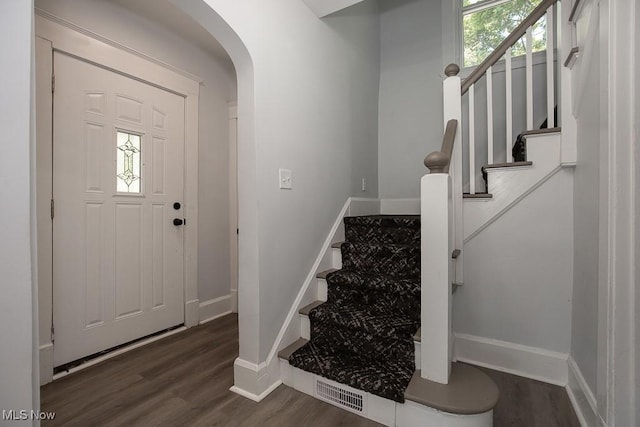 381 Watson St, Akron, OH 44305 - entrance foyer featuring stairway, dark wood-style floors, and arched walkways