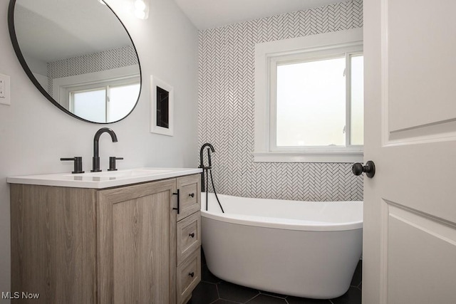 381 Watson St, Akron, OH 44305 - full bathroom with vanity, a freestanding tub, and tile patterned floors