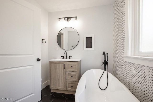 381 Watson St, Akron, OH 44305 - full bath with a freestanding tub, vanity, and tile patterned floors