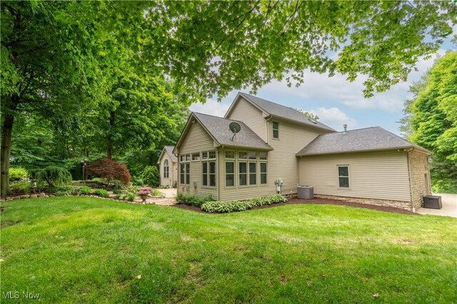 1588 Eagle Watch St NE, Canton, OH 44721 - back of house featuring a lawn and a sunroom