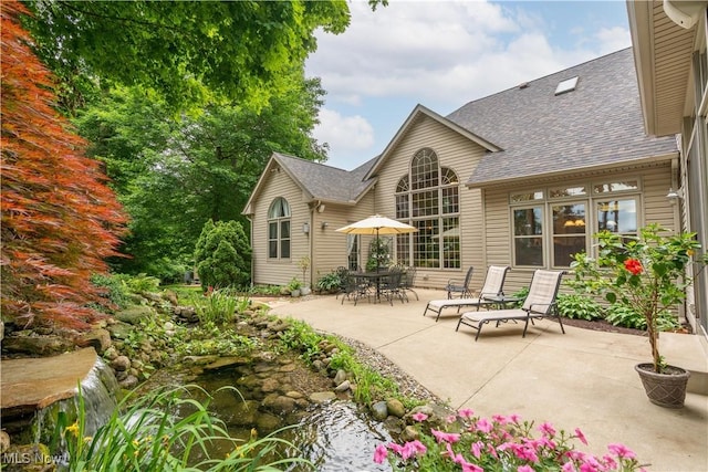 1588 Eagle Watch St NE, Canton, OH 44721 - back of house with a patio area and roof with shingles