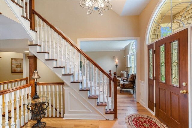1588 Eagle Watch St NE, Canton, OH 44721 - foyer with wood finished floors, a chandelier, a high ceiling, and stairway