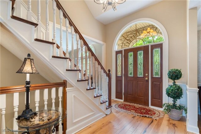 1588 Eagle Watch St NE, Canton, OH 44721 - entrance foyer with hardwood / wood-style floors, a towering ceiling, stairway, and a chandelier