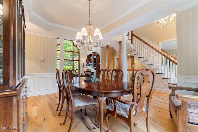 1588 Eagle Watch St NE, Canton, OH 44721 - dining room featuring a chandelier, light wood finished floors, a decorative wall, a wainscoted wall, and wallpapered walls