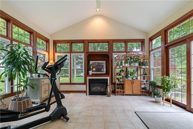 1588 Eagle Watch St NE, Canton, OH 44721 - exercise area featuring vaulted ceiling, light tile patterned floors, and a glass covered fireplace