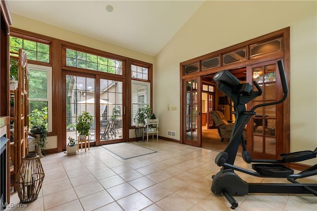 1588 Eagle Watch St NE, Canton, OH 44721 - workout room featuring french doors, healthy amount of natural light, light tile patterned flooring, and high vaulted ceiling