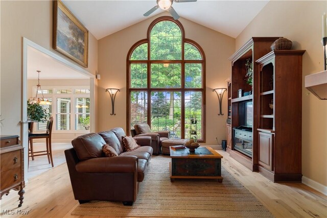 1588 Eagle Watch St NE, Canton, OH 44721 - living room featuring ceiling fan, high vaulted ceiling, light wood-style flooring, and plenty of natural light
