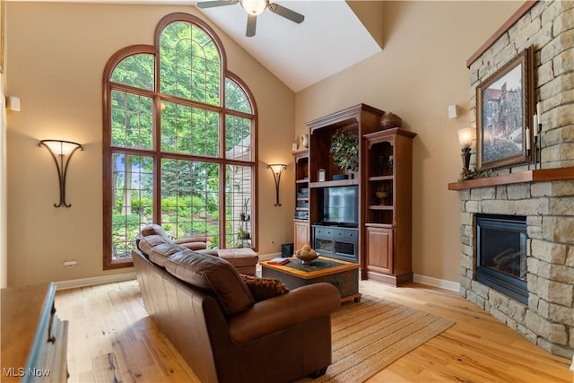 1588 Eagle Watch St NE, Canton, OH 44721 - living area featuring high vaulted ceiling, a ceiling fan, light wood-style floors, and a fireplace