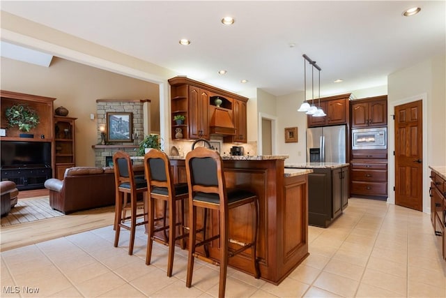 1588 Eagle Watch St NE, Canton, OH 44721 - kitchen with appliances with stainless steel finishes, a peninsula, light tile patterned floors, a kitchen bar, and open shelves