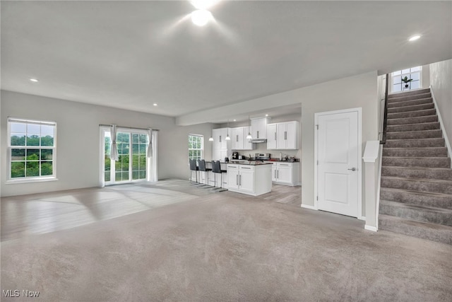 1633 Duncan Way, Streetsboro, OH 44241 - unfurnished living room featuring light carpet, stairs, and recessed lighting