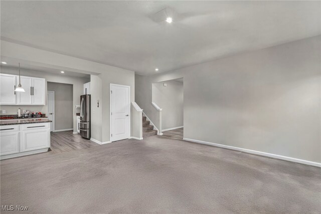 1633 Duncan Way, Streetsboro, OH 44241 - unfurnished living room featuring light colored carpet, recessed lighting, and stairway