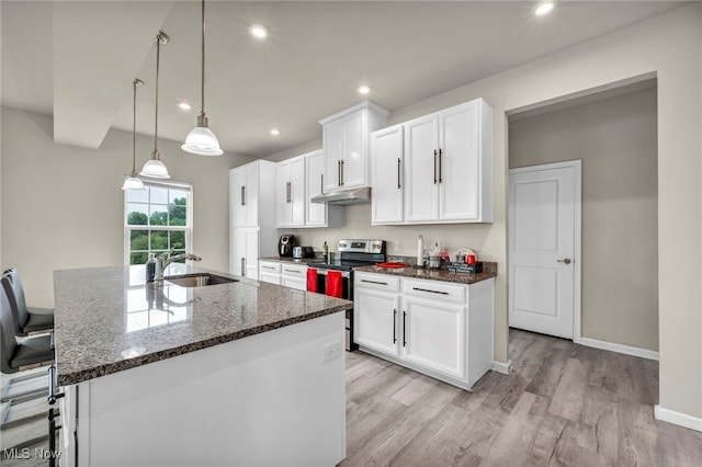 1633 Duncan Way, Streetsboro, OH 44241 - kitchen with stainless steel electric range, under cabinet range hood, light wood-style floors, dark stone counters, and white cabinets