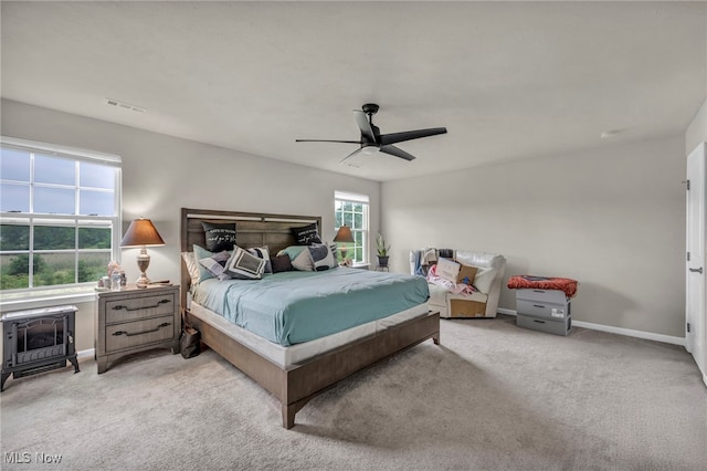1633 Duncan Way, Streetsboro, OH 44241 - carpeted bedroom with ceiling fan and a wood stove