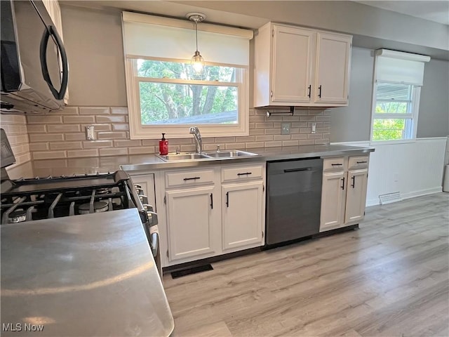 3061 Greenwich Ln, Brunswick, OH 44212 - kitchen featuring dishwasher, black microwave, stainless steel countertops, and white cabinetry