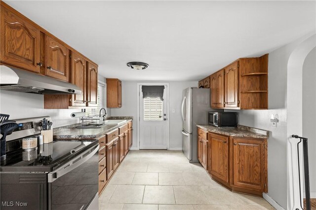 1309 7th St N, Martins Ferry, OH 43935 - kitchen featuring under cabinet range hood, stainless steel appliances, arched walkways, brown cabinets, and open shelves
