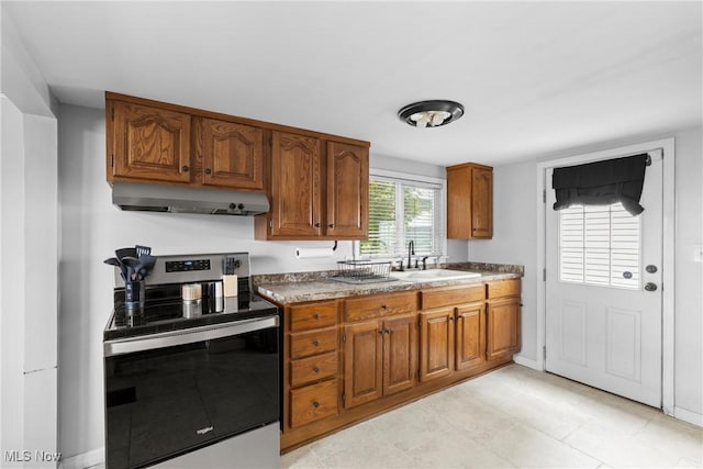 1309 7th St N, Martins Ferry, OH 43935 - kitchen featuring stainless steel range with electric cooktop, extractor fan, brown cabinets, and light tile patterned floors