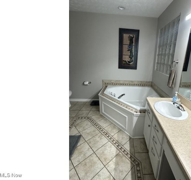 324 Buttermere Ln, Amherst, OH 44001 - bathroom with vanity, a bath, tile patterned floors, and a textured ceiling