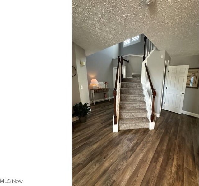 324 Buttermere Ln, Amherst, OH 44001 - staircase with wood finished floors and a textured ceiling