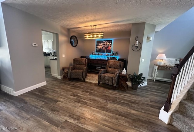 324 Buttermere Ln, Amherst, OH 44001 - living area featuring stairway, dark wood-type flooring, and a textured ceiling