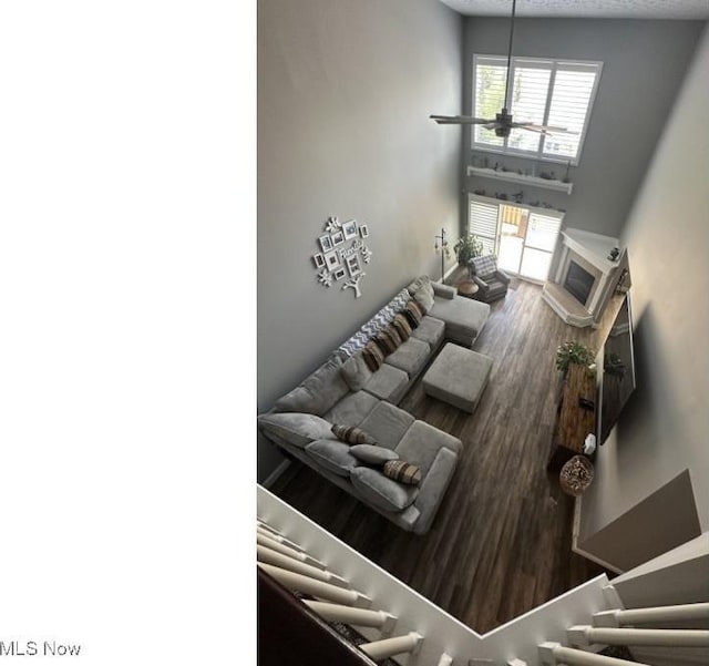 324 Buttermere Ln, Amherst, OH 44001 - living area featuring wood finished floors, a textured ceiling, and a ceiling fan