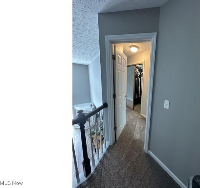 324 Buttermere Ln, Amherst, OH 44001 - hall with an upstairs landing, dark carpet, and a textured ceiling