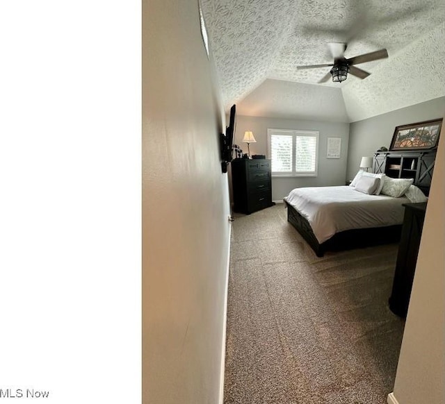324 Buttermere Ln, Amherst, OH 44001 - bedroom with carpet flooring, a textured ceiling, vaulted ceiling, and a ceiling fan