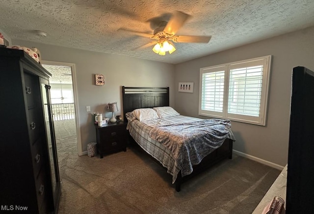 324 Buttermere Ln, Amherst, OH 44001 - carpeted bedroom with multiple windows, a textured ceiling, and ceiling fan