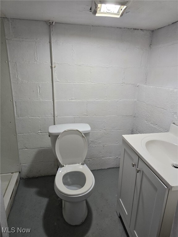 4175 E 95th St, Cleveland, OH 44105 - bathroom featuring vanity, unfinished concrete flooring, and concrete block wall