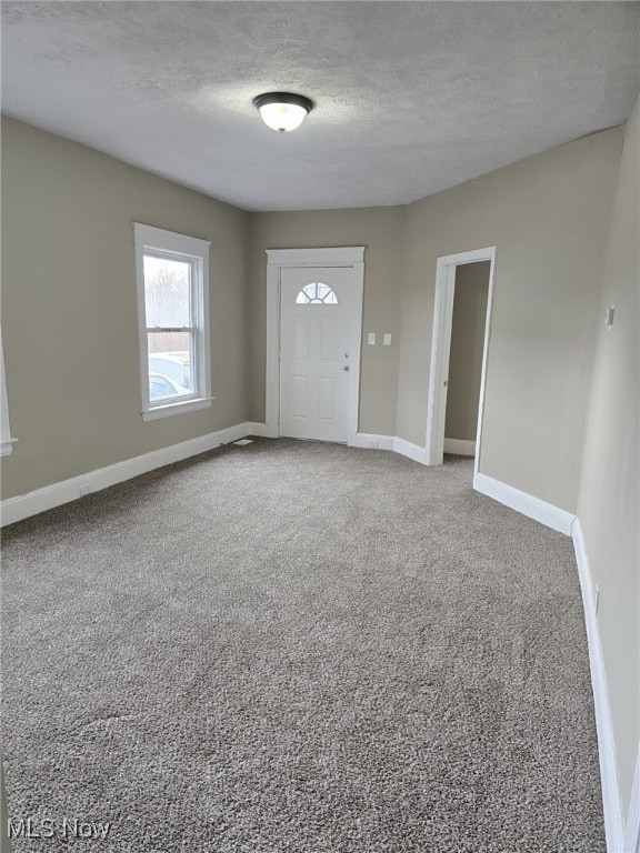 4175 E 95th St, Cleveland, OH 44105 - carpeted foyer entrance featuring a textured ceiling and baseboards