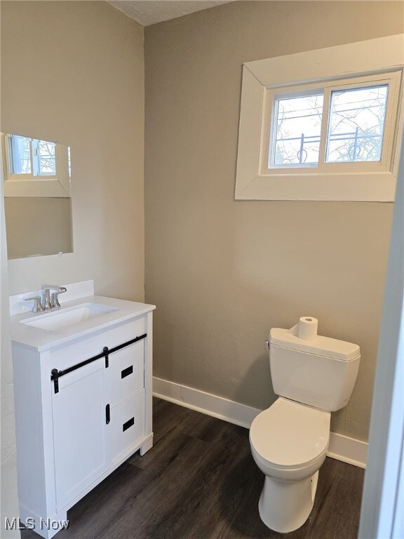 4175 E 95th St, Cleveland, OH 44105 - half bath featuring vanity and wood finished floors