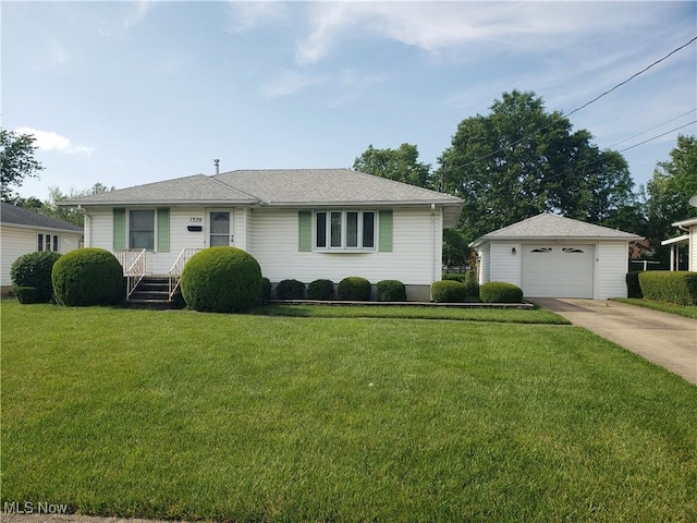 1320 W 40th St, Lorain, OH 44053 - view of front of house with concrete driveway, an outdoor structure, a detached garage, and a front yard