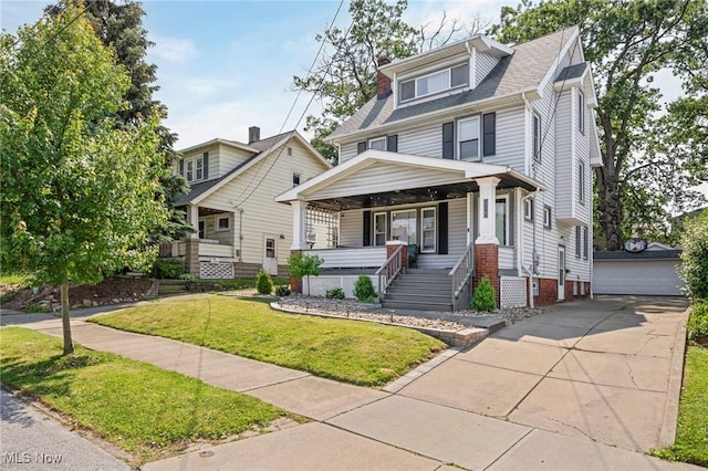 1646 Wyandotte Ave, Lakewood, OH 44107 - traditional style home with a porch, a front yard, a detached garage, an outbuilding, and a shingled roof
