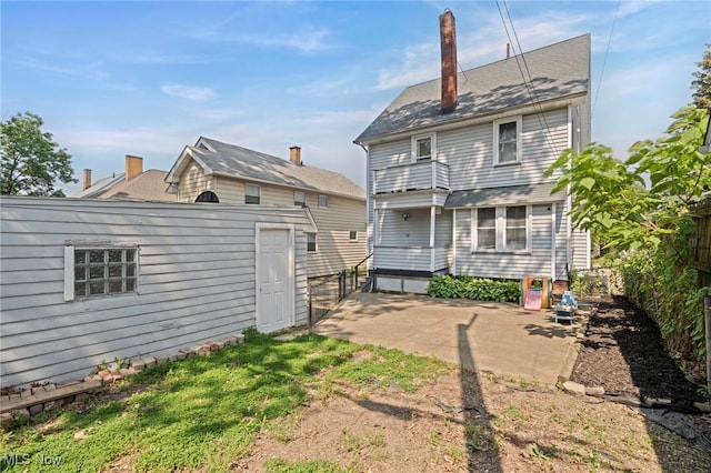 1646 Wyandotte Ave, Lakewood, OH 44107 - back of house with a patio, an outbuilding, and a chimney