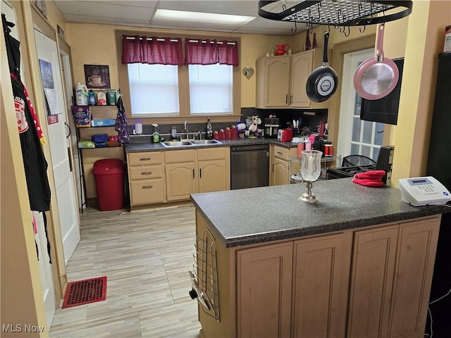 1038 Quincy St, Parkersburg, WV 26101 - kitchen featuring dishwasher, dark countertops, a peninsula, light wood-style floors, and tasteful backsplash