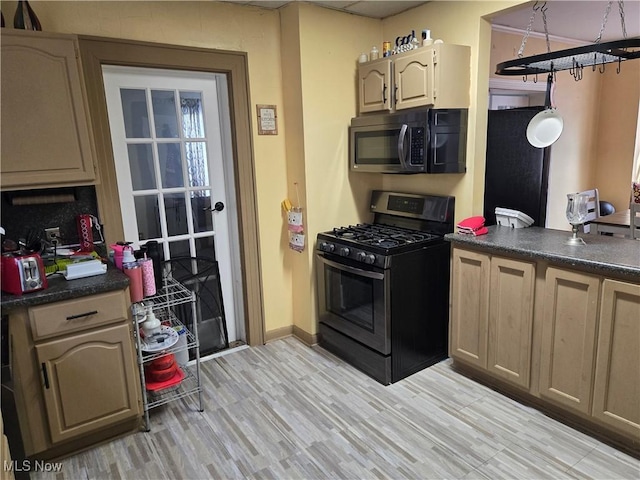 1038 Quincy St, Parkersburg, WV 26101 - kitchen with gas stove, dark countertops, and light wood-type flooring