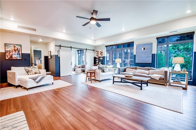 2044 Random Rd Unit 303, Cleveland, OH 44106 - living area featuring ceiling fan, a barn door, wood finished floors, and recessed lighting