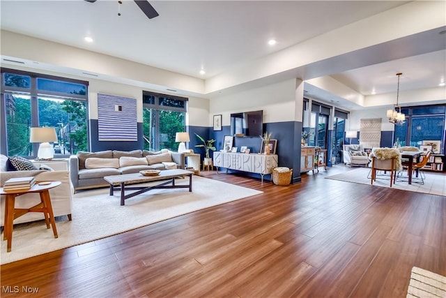 2044 Random Rd Unit 303, Cleveland, OH 44106 - living room with a raised ceiling, ceiling fan, wood finished floors, a chandelier, and recessed lighting