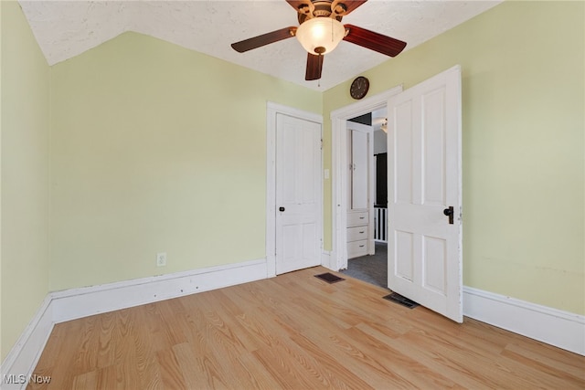 2117 Woodward Ave, Lakewood, OH 44107 - unfurnished bedroom with wood finished floors, vaulted ceiling, and ceiling fan