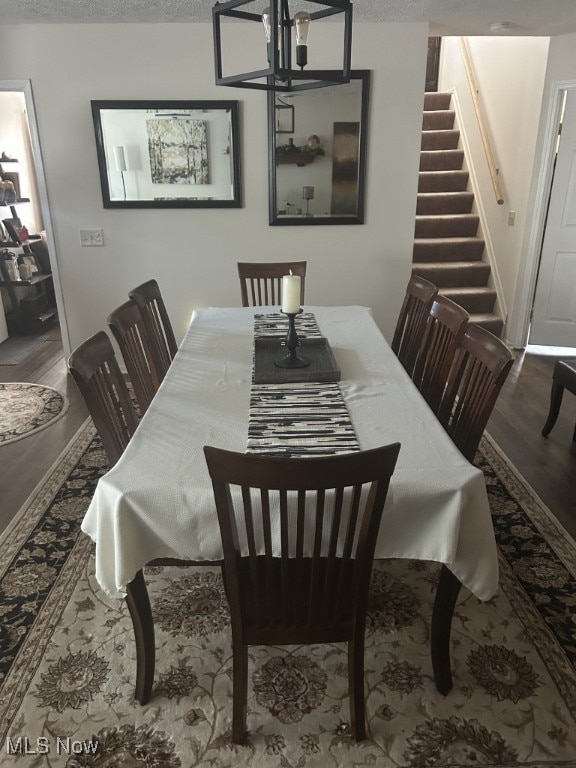 8050 Harbor Creek Dr Unit 1903, Mentor-On-The-Lake, OH 44060 - dining area with stairway, wood finished floors, and a chandelier