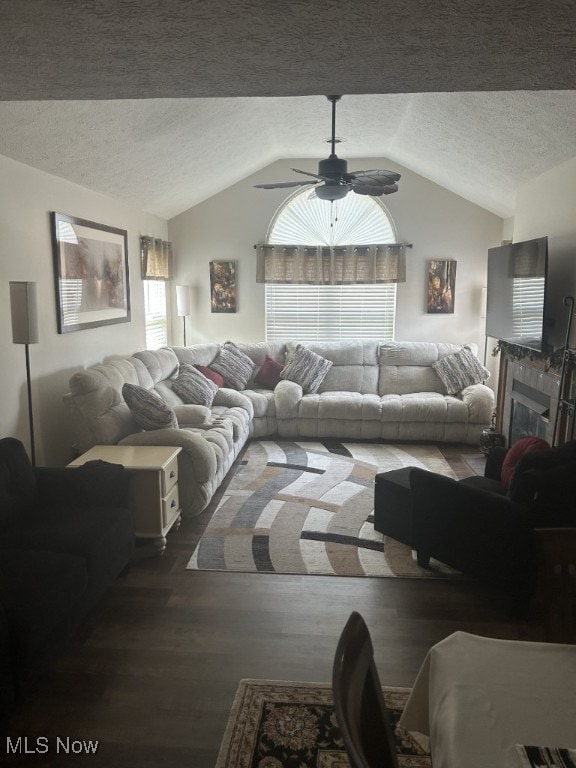 8050 Harbor Creek Dr Unit 1903, Mentor-On-The-Lake, OH 44060 - living room featuring lofted ceiling, a textured ceiling, wood finished floors, ceiling fan, and a fireplace