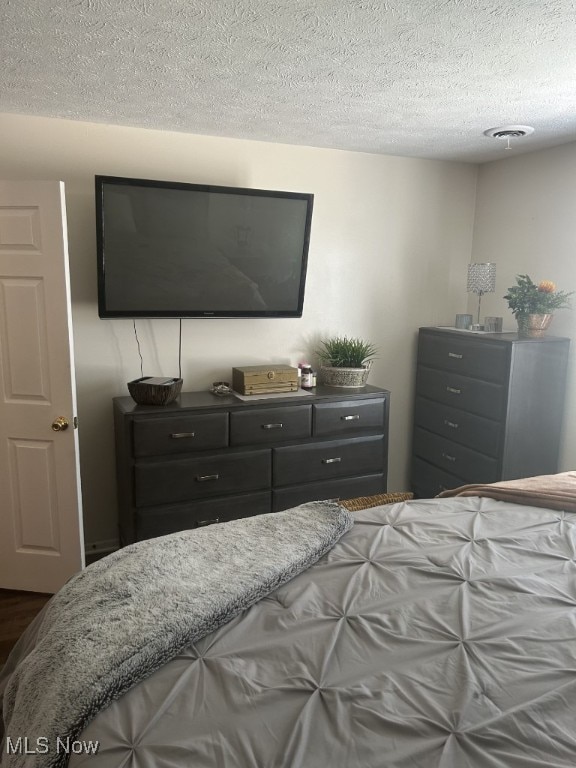 8050 Harbor Creek Dr Unit 1903, Mentor-On-The-Lake, OH 44060 - bedroom with a textured ceiling and dark wood-style floors