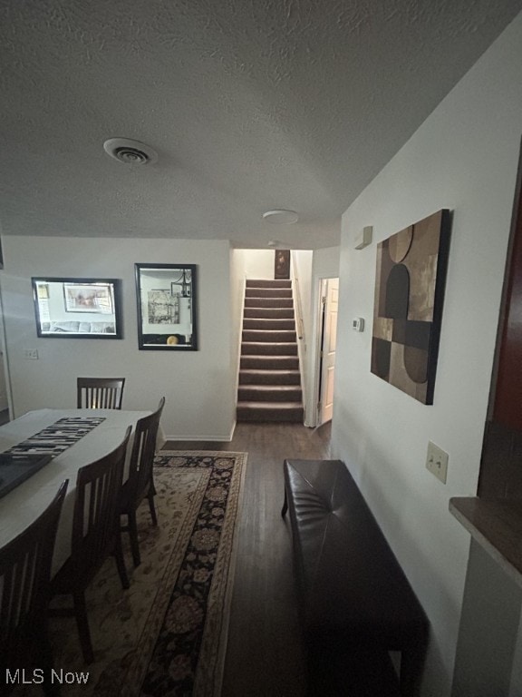 8050 Harbor Creek Dr Unit 1903, Mentor-On-The-Lake, OH 44060 - dining area with stairs, wood finished floors, and a textured ceiling