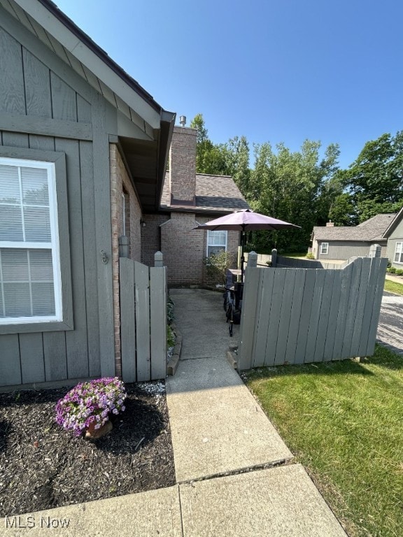 8050 Harbor Creek Dr Unit 1903, Mentor-On-The-Lake, OH 44060 - view of property exterior with board and batten siding, a chimney, and brick siding
